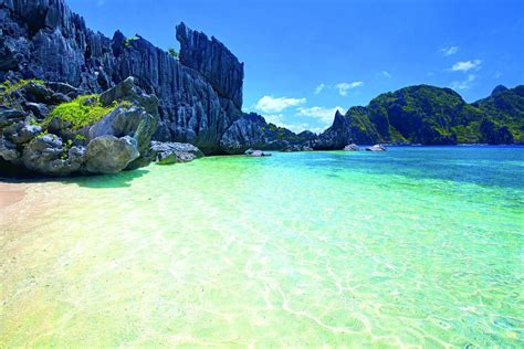 Tropical beach in Palawan with turquoise waters and palm trees, Philippines