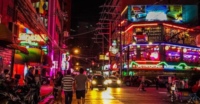 Group of expats taking a Grab outside a Manila nightlife district at night