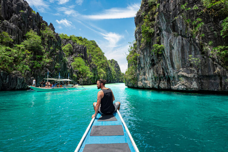Travelers on a budget exploring El Nido lagoons in Palawan, Philippines