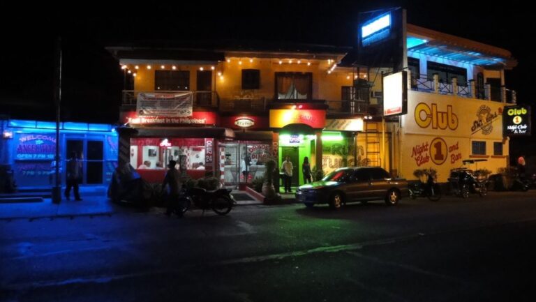 Barrio Barretto nightlife street in Subic Bay with neon bar signs and open-front bars at night